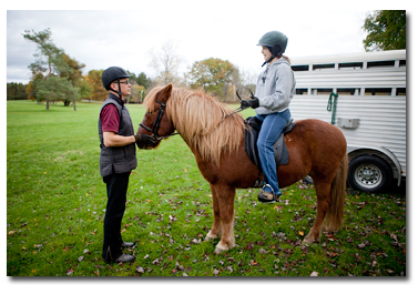 Steve preparing a student for a lesson out on the trail